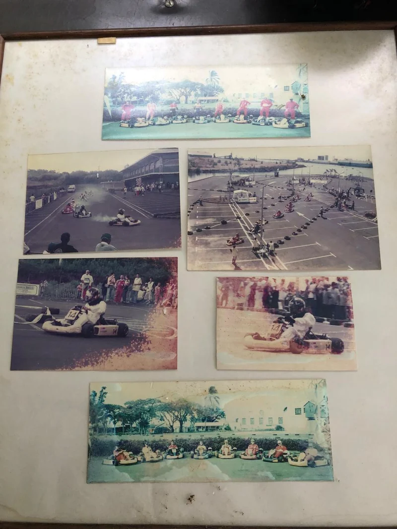 A physical board holding six older photographs of karting, grids and local venues.