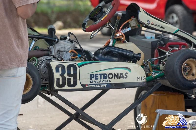 Worn Petronas 39 bodywork and mechanical parts on a raised kart.
